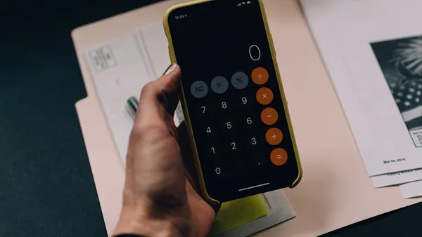Calculator and financial charts showing pricing calculation