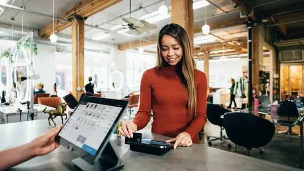 Person holding credit card performing e-commerce analysis