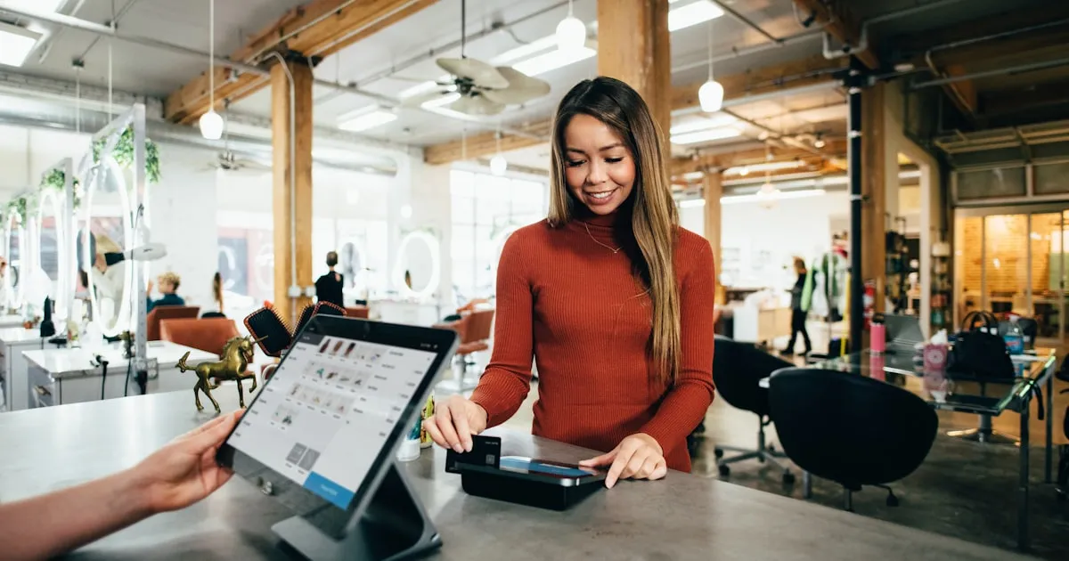 Person holding credit card performing e-commerce analysis