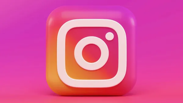 Person using smartphone showing Instagram content for social media marketing research